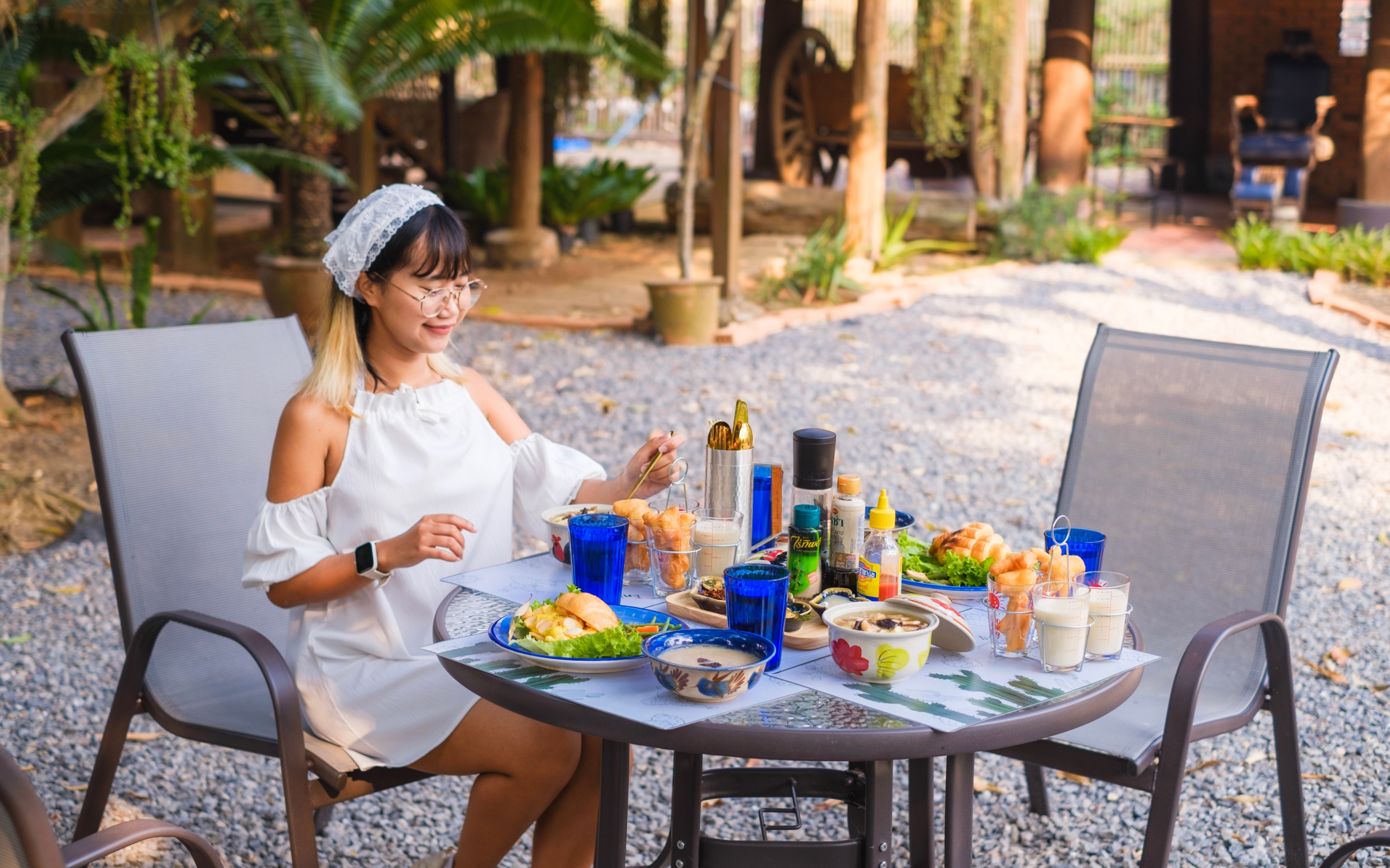 A woman sitting at a table, calmly engaged in her meal
