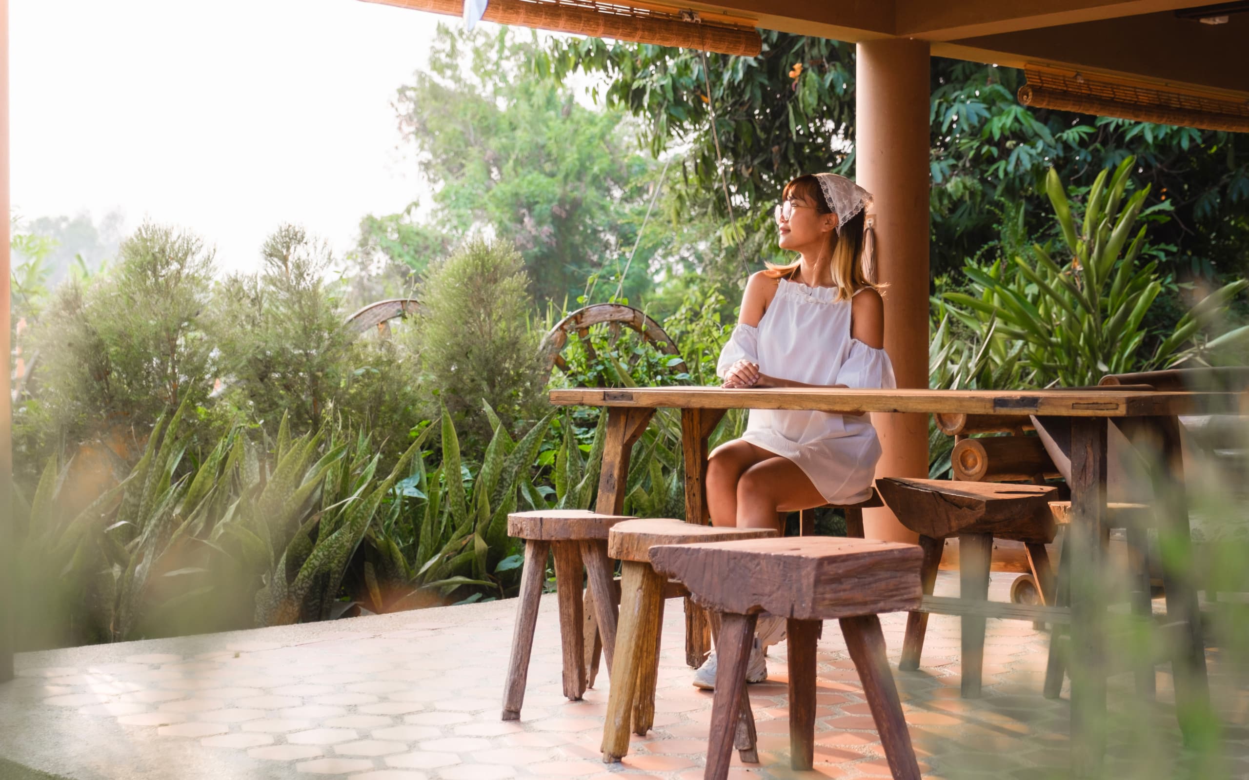 A woman sitting at a table with stools
