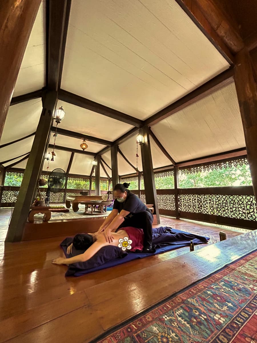 A woman getting a massage on a wooden floor