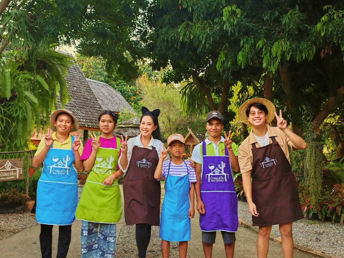 Multiple people in aprons posing together