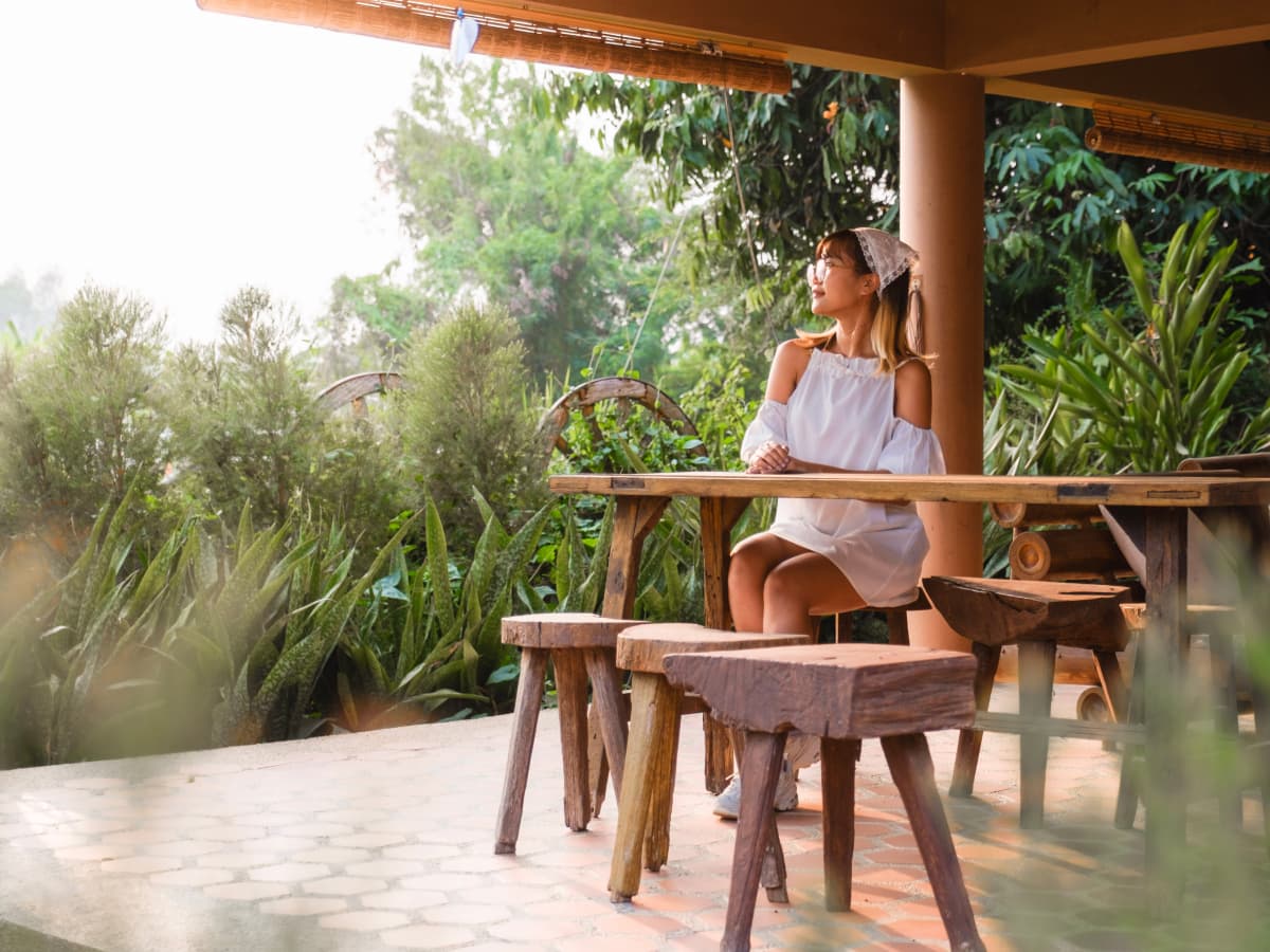 A woman sitting at a table with stools