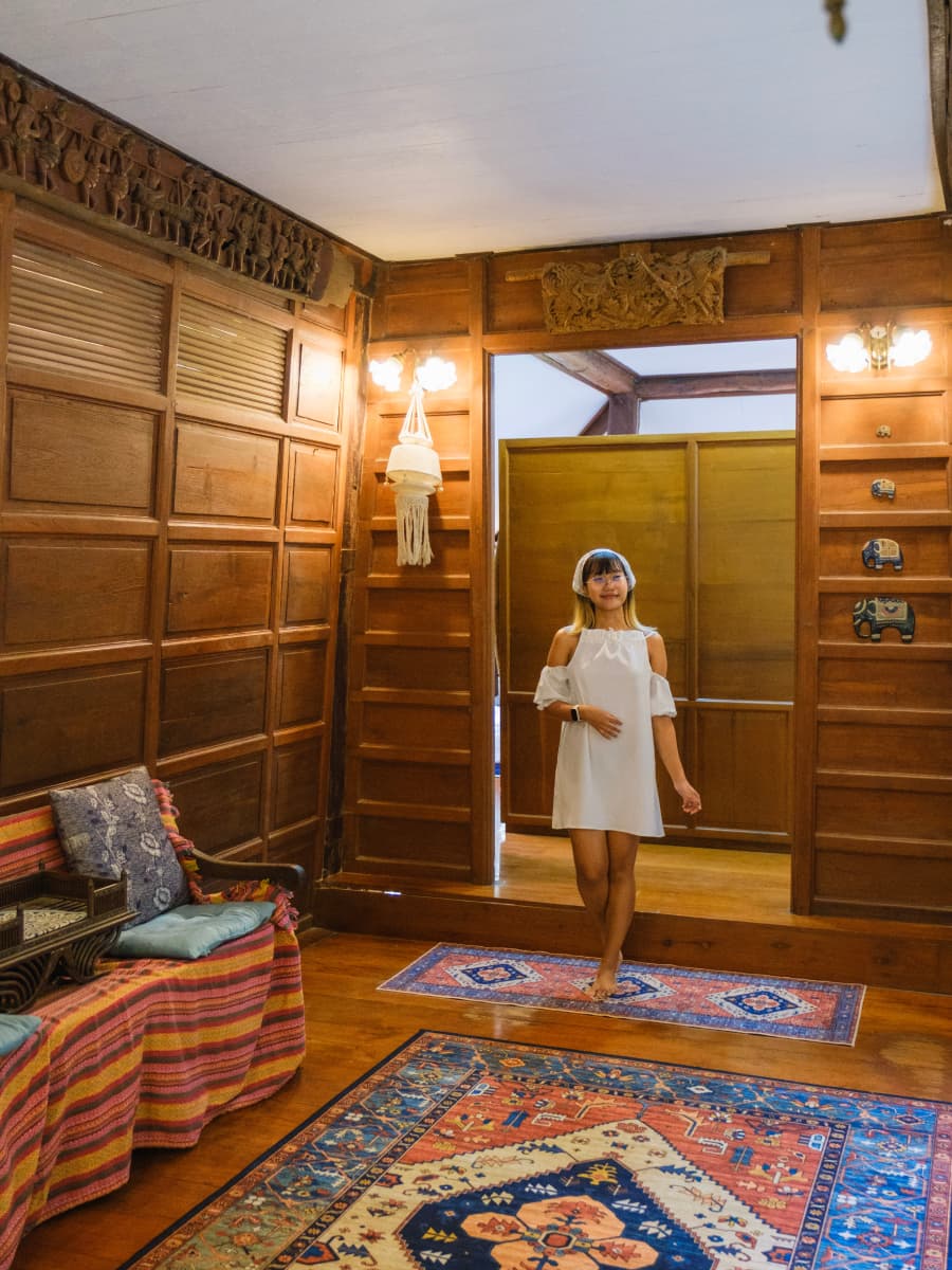 A woman entering a carpeted living room