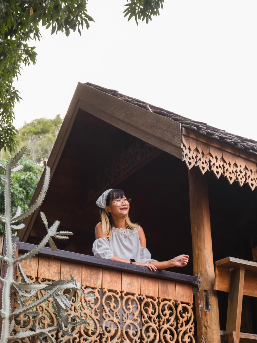 A woman standing on a wooden balcony