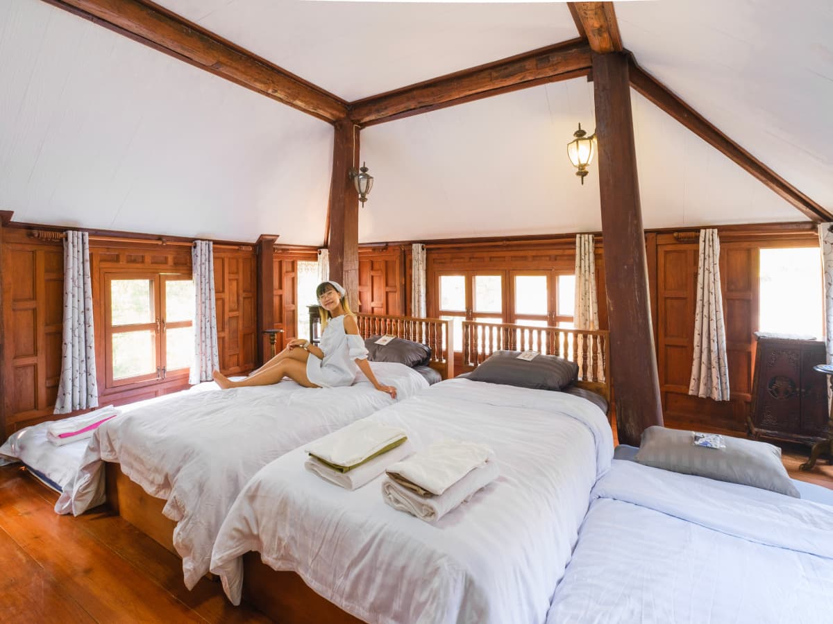 A woman in a sitting on a bed