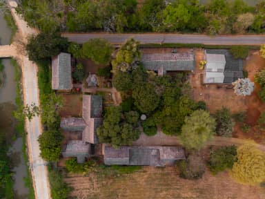 Aerial view of rural houses and trees in a peaceful countryside setting